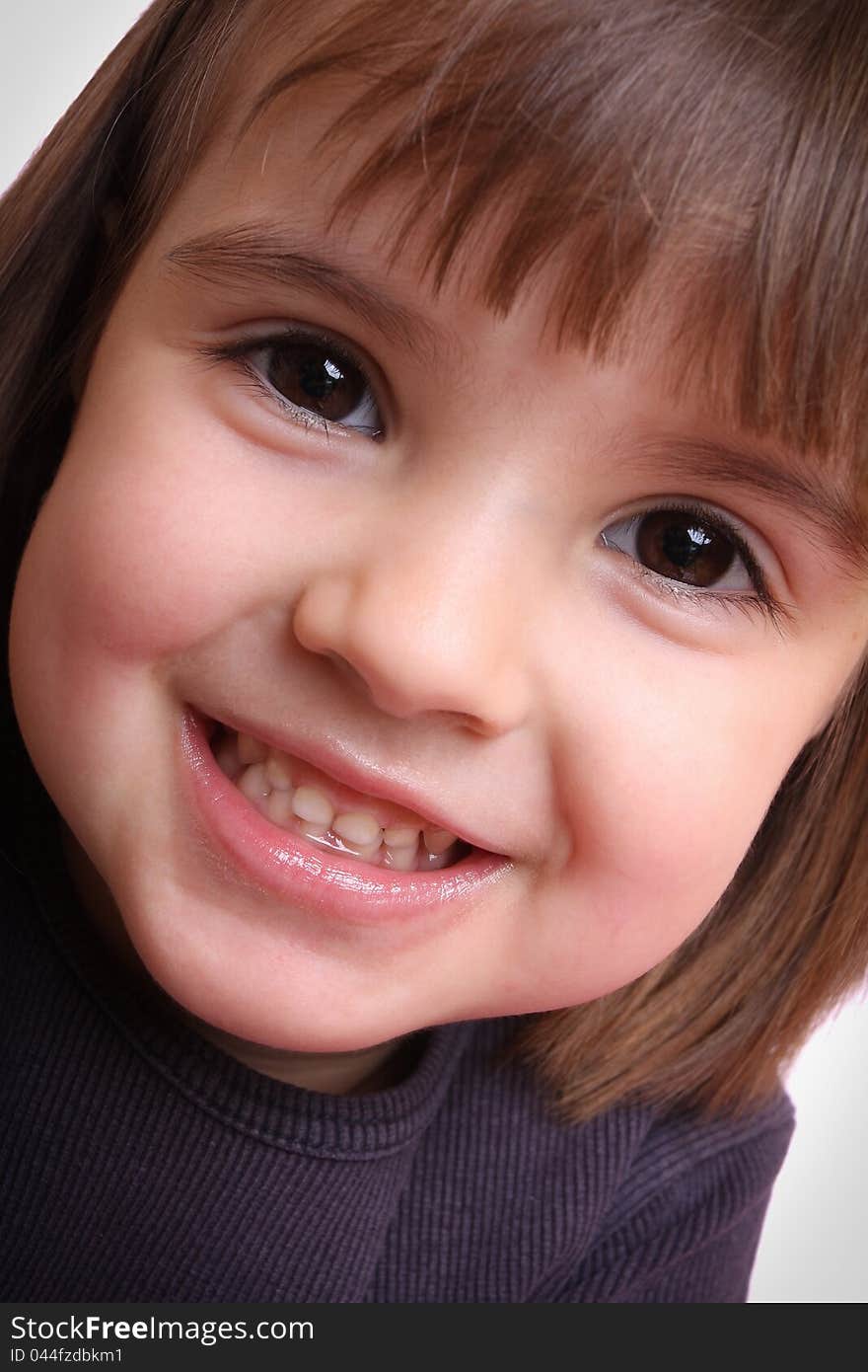 Portrait Of A Beautiful Little Girl In A Purple Mo