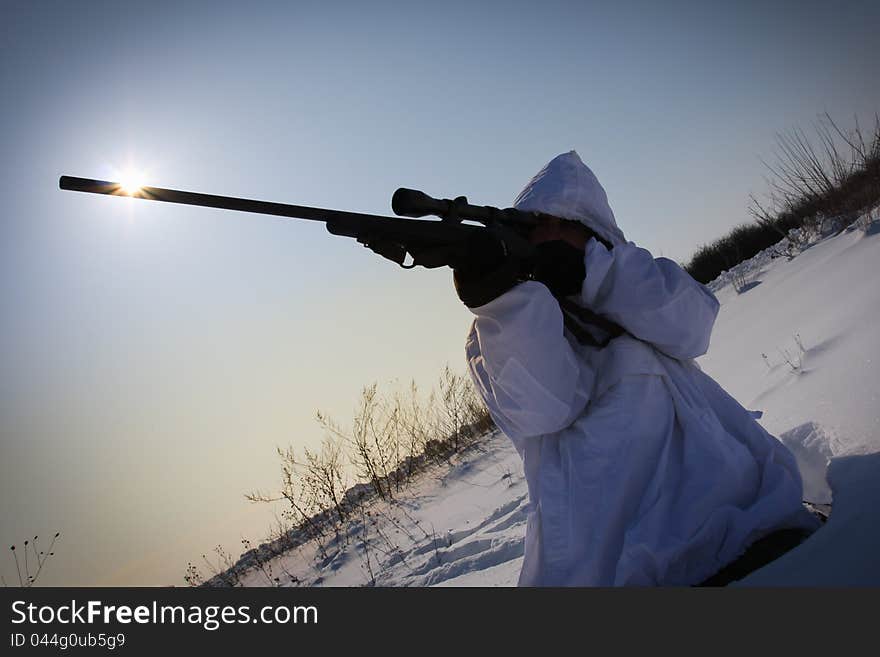 Man preparing to take a long shot during a winter blizzard. Man preparing to take a long shot during a winter blizzard