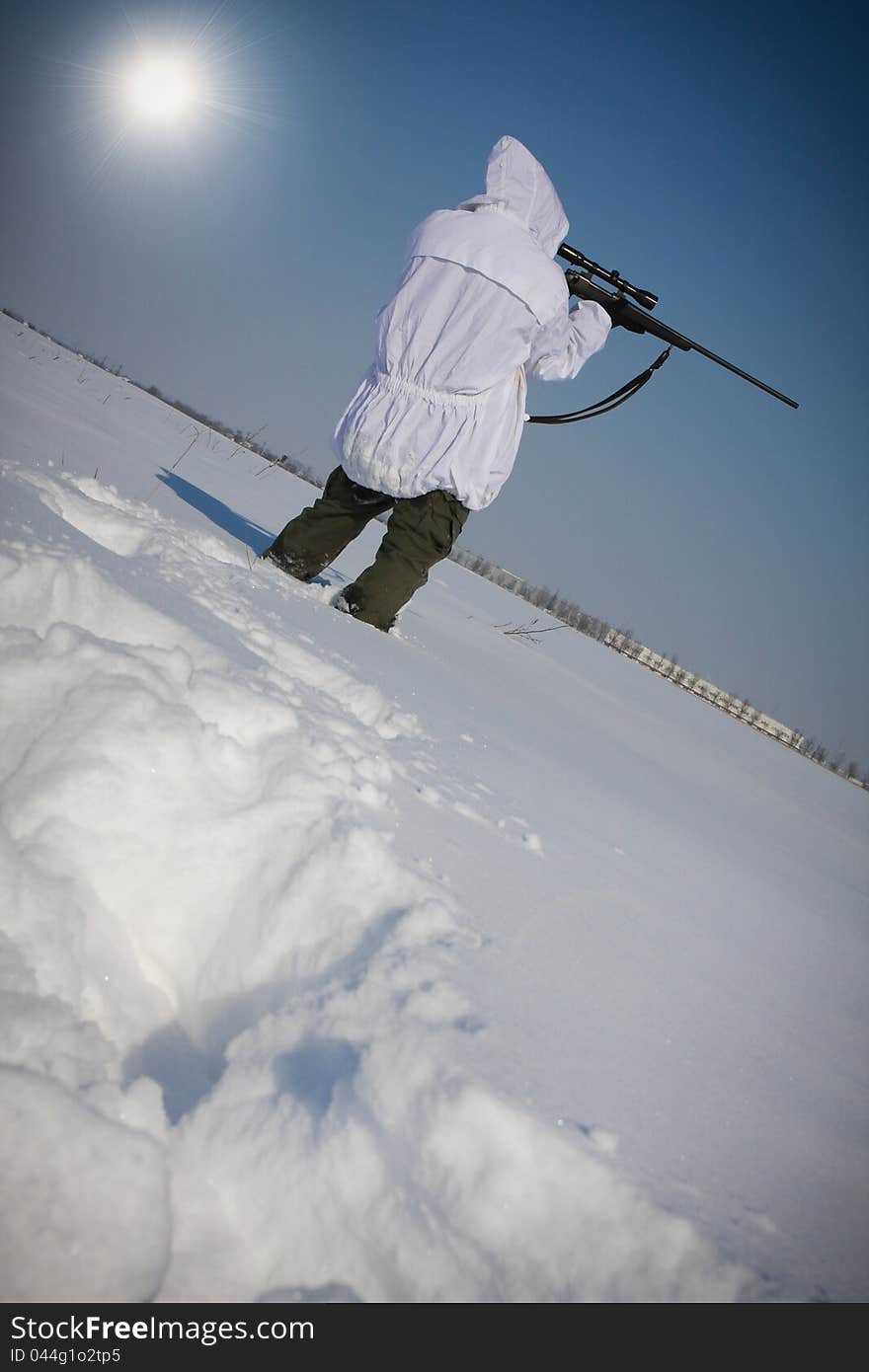 Man preparing to take a long shot during a winter blizzard. Man preparing to take a long shot during a winter blizzard