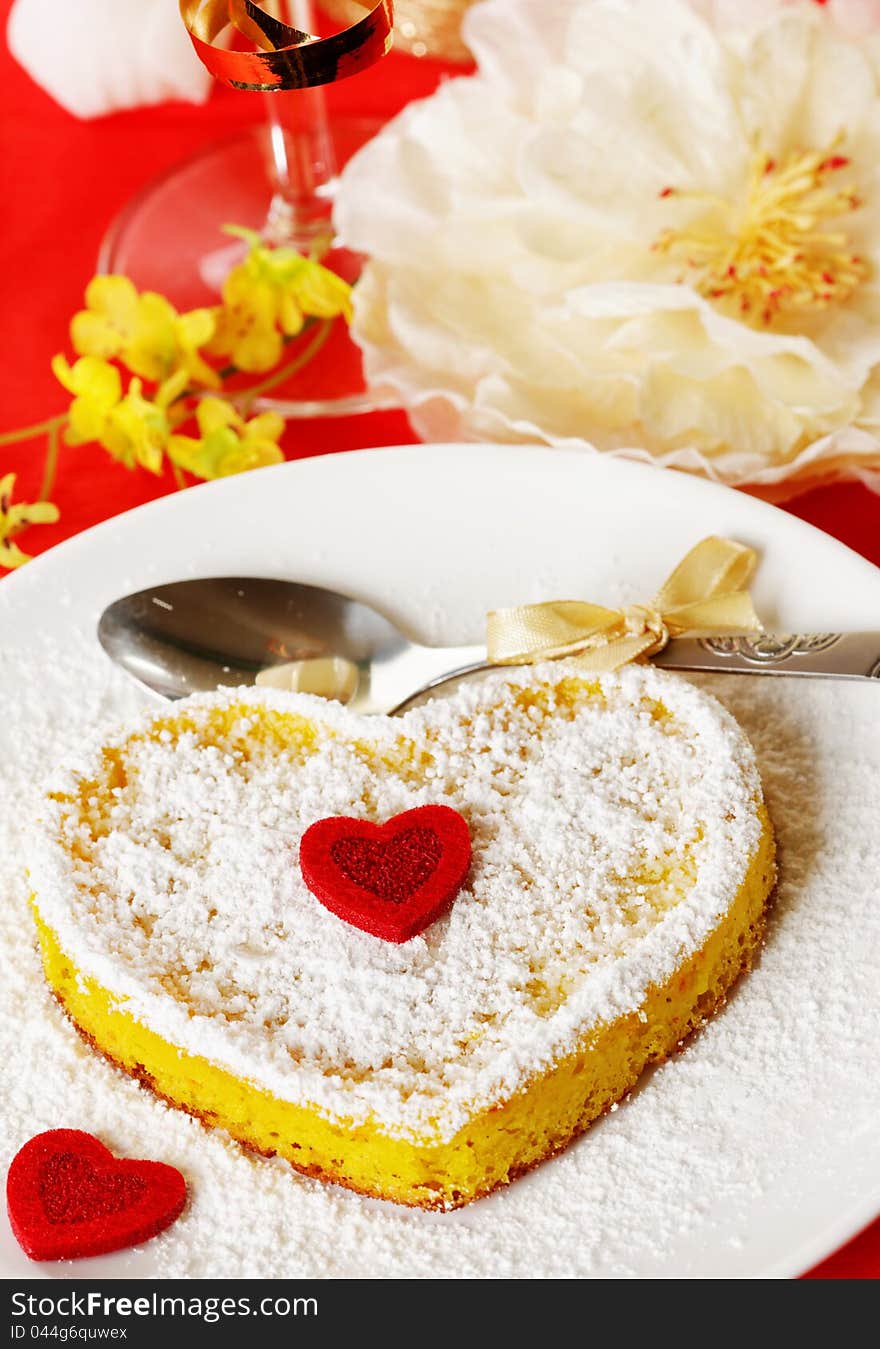 Sweet cake in heart shape on a plate