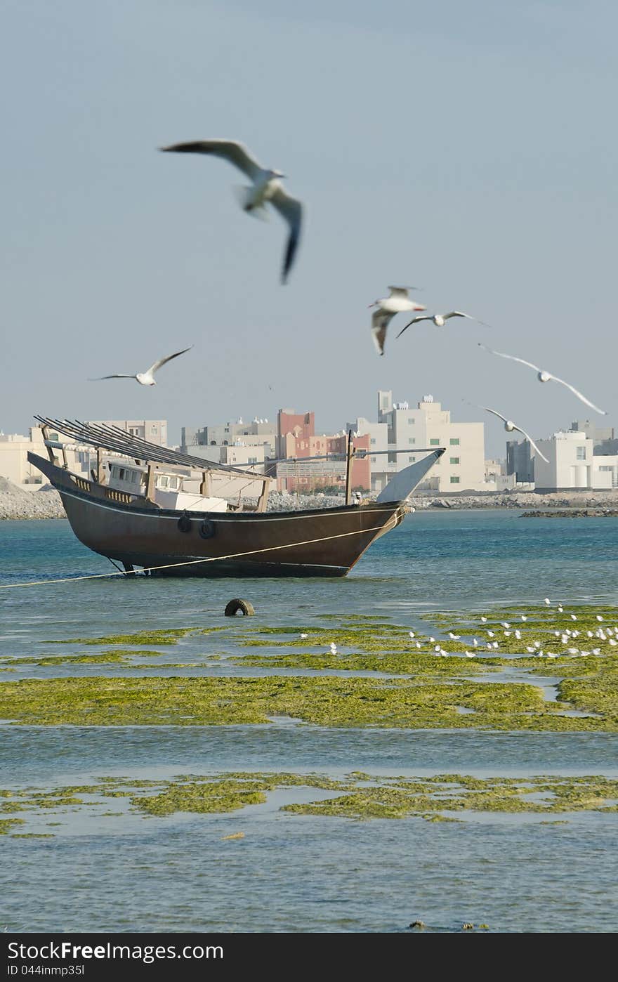 Old fishing boat on the sea and seagulls