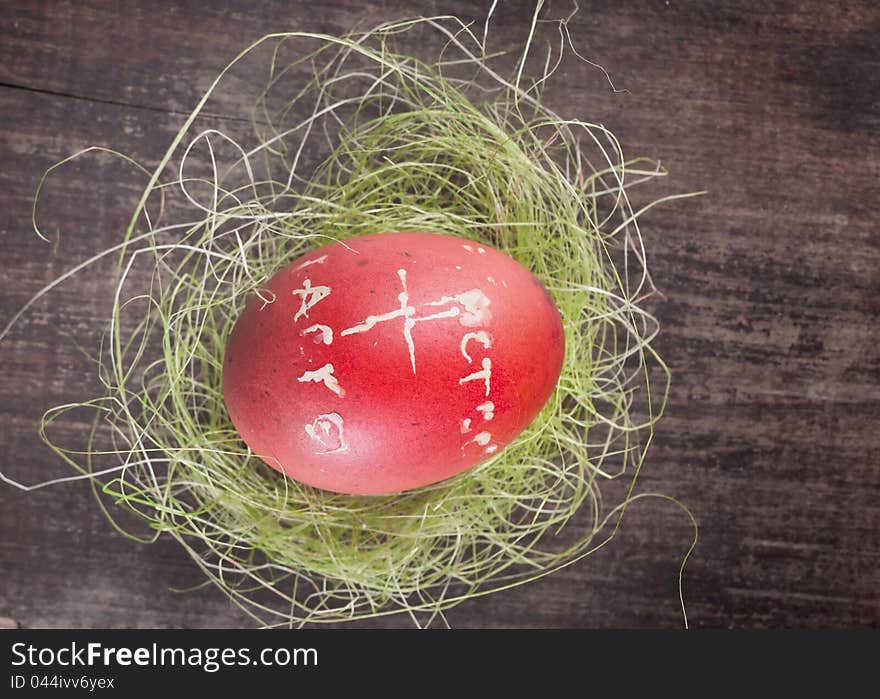 Red easter egg on wooden plank