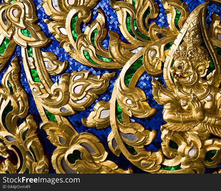 Wood carvings is a form of Thai art and painted black paint over the designs with gold