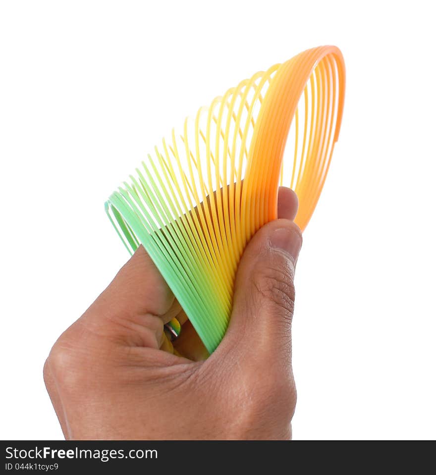 Hand Holding A Colorful Slinky Toy. Hand Holding A Colorful Slinky Toy