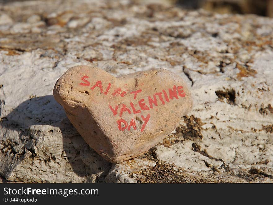 Closeup shot over a stone heart for the day of Saint Valentine, annual commemoration held on February 14 celebrating love and affection between intimate companions. Closeup shot over a stone heart for the day of Saint Valentine, annual commemoration held on February 14 celebrating love and affection between intimate companions