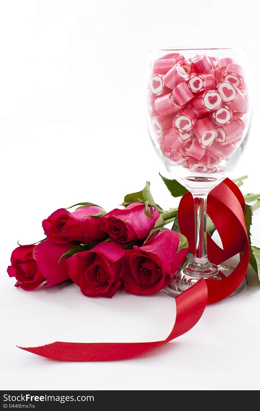 Valentine Series, Candy in wine glass with rose on white background