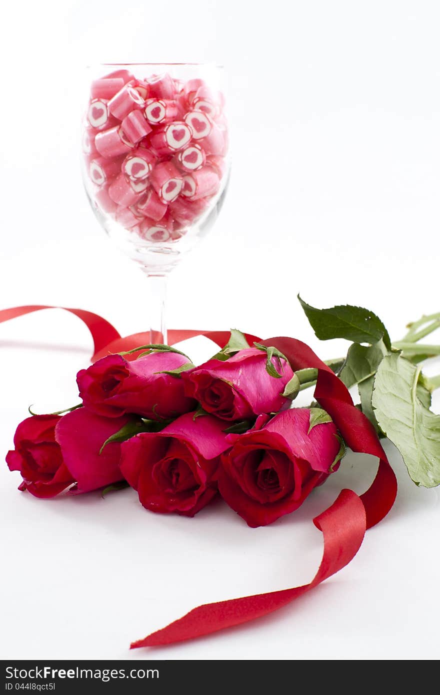 Valentine Series, Candy in wine glass with rose on white background