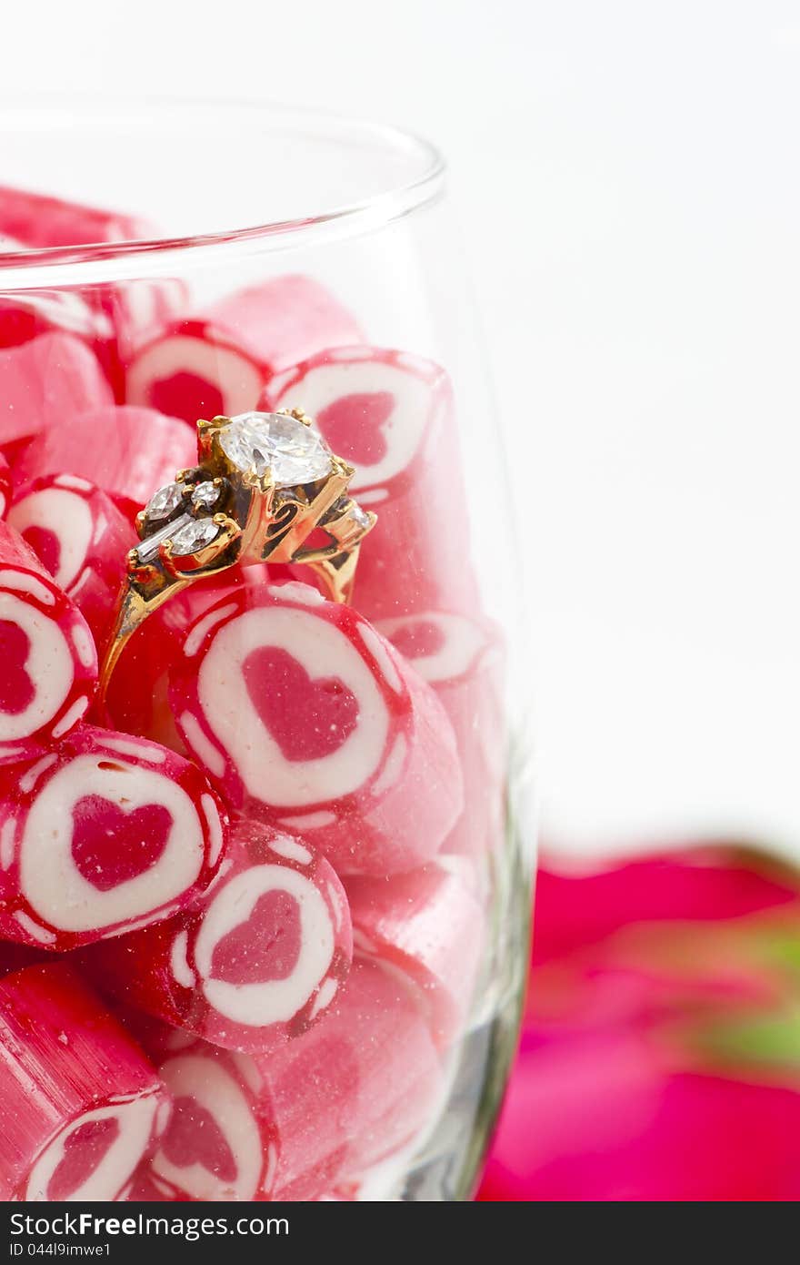 Valentine Series, Diamond Ring and Candy in wine glass on white background