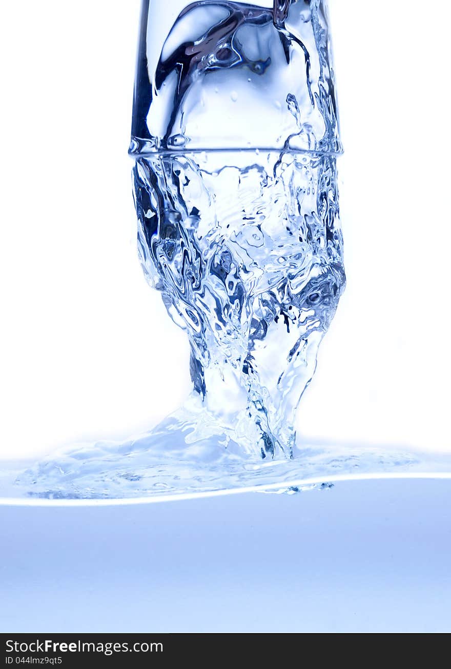 Water splashing from glass isolated on white