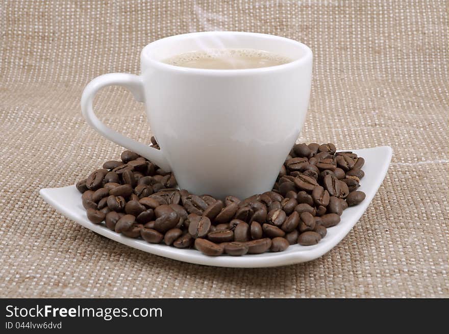 Coffee and milk and saucer with grains