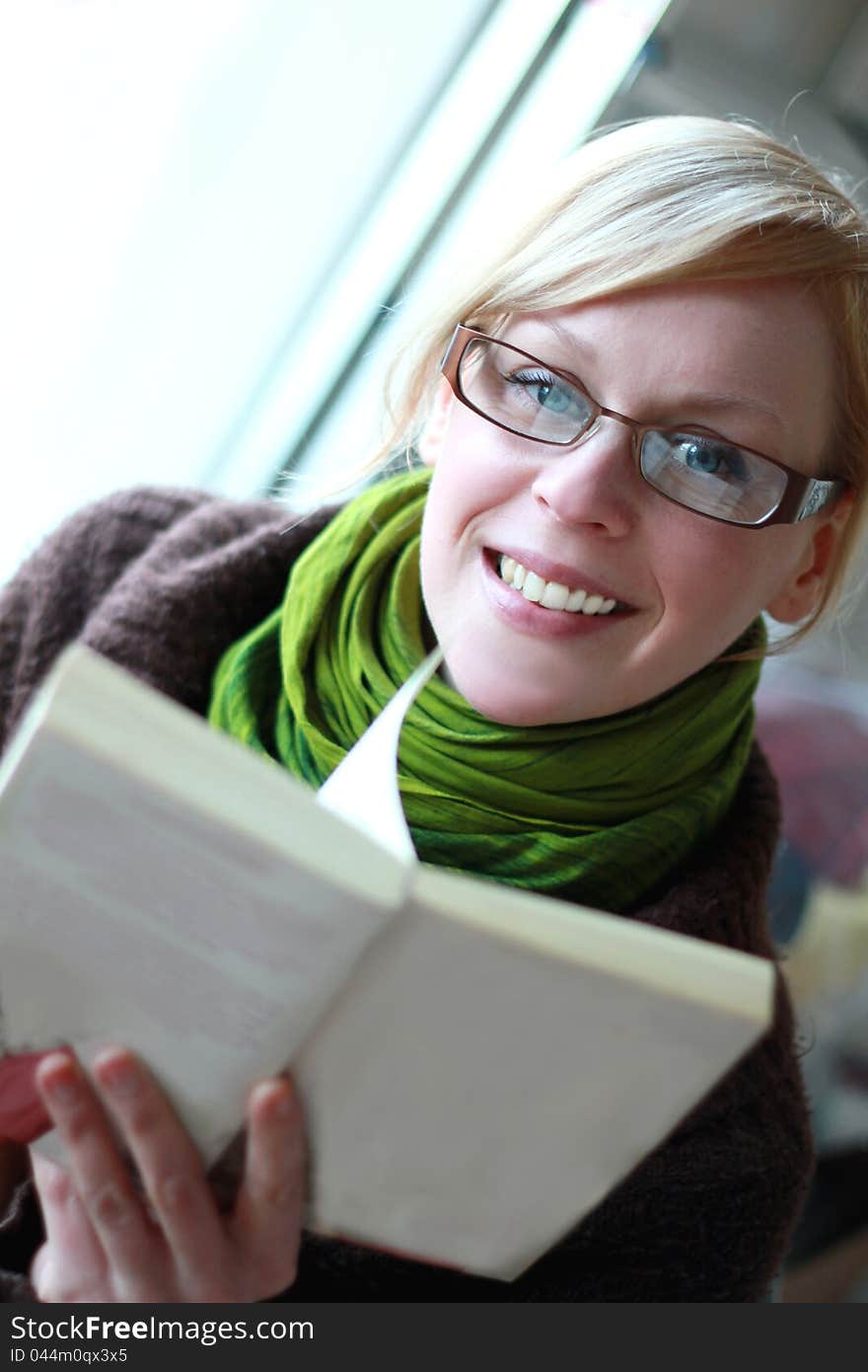 A young woman reading a book on a  cold winter's day. A young woman reading a book on a  cold winter's day