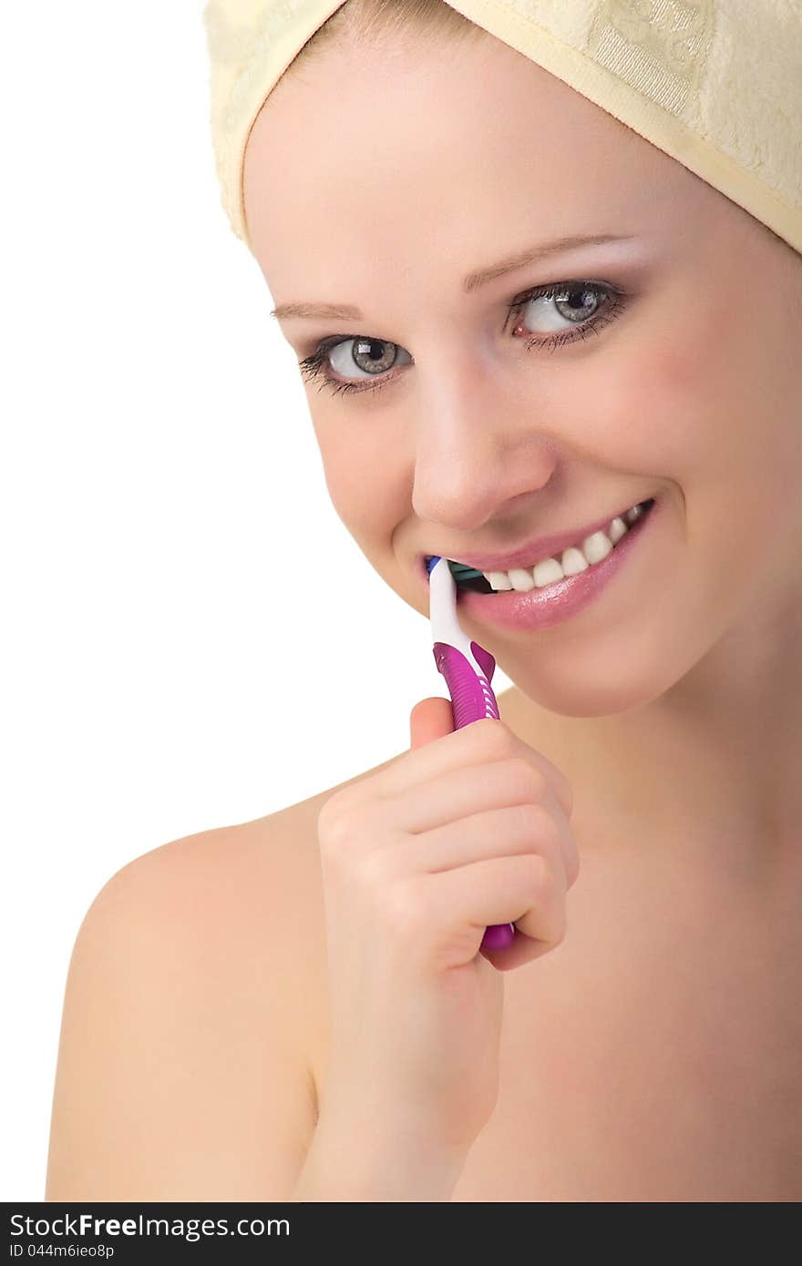 Healthy  girl in a towel cleans teeth with a toothbrush isolated on white background. Healthy  girl in a towel cleans teeth with a toothbrush isolated on white background