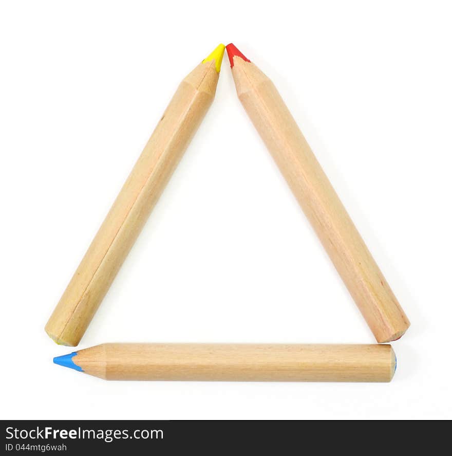 Colored Pencils set as a triangle frame on white