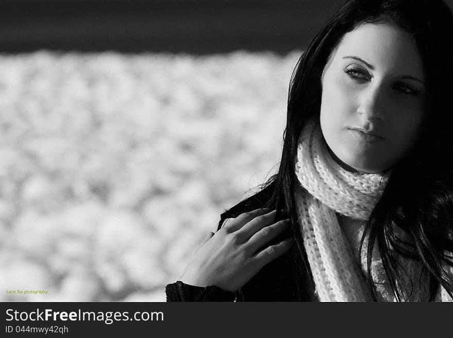 Young woman outdoor portrait on blue airy background in black and white technique