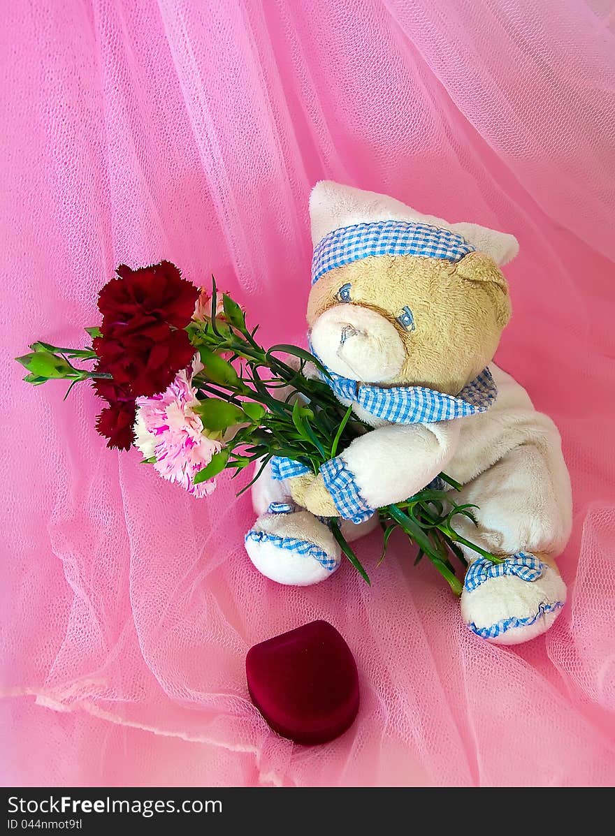 Sad love teddy bear with flowers and gifts. Pink.