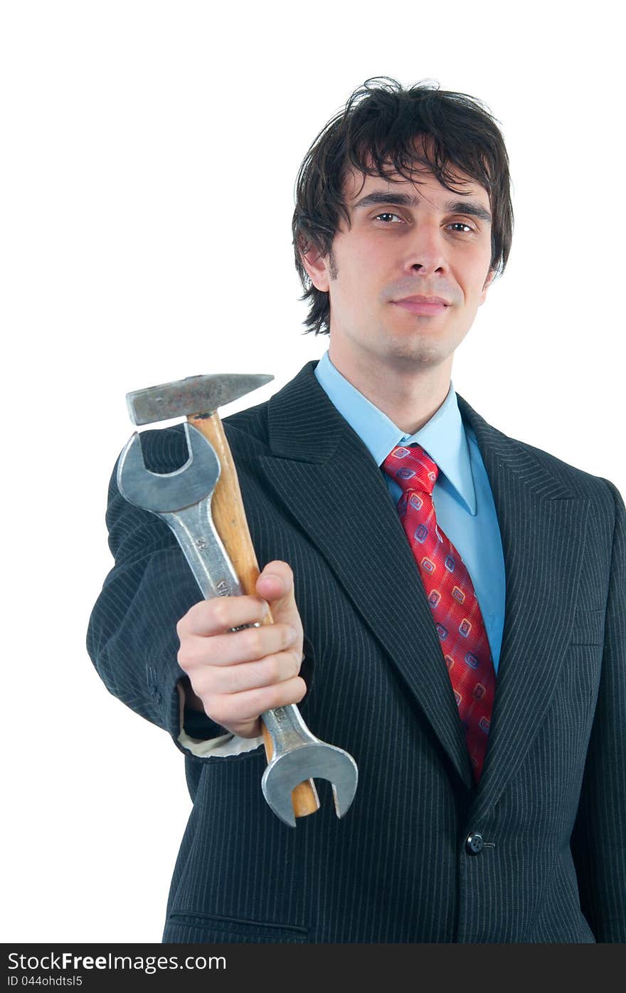 Elegant smiling businessman handing out hammer and wrench isolated on white.