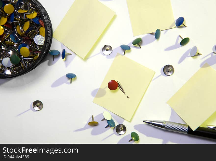 Thumb tacks, one standing up from above. Thumb tacks, one standing up from above