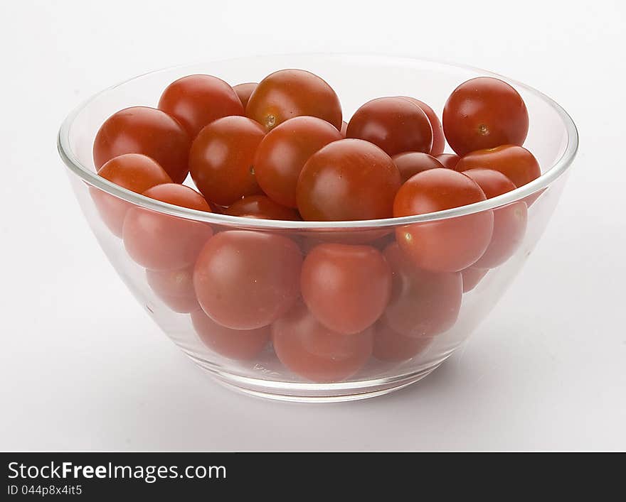 A lot of tomatoes cherry in the glass bowl