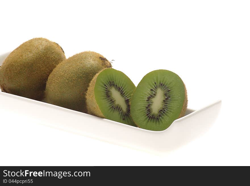 Kiwi with white bowl on white background. Kiwi with white bowl on white background