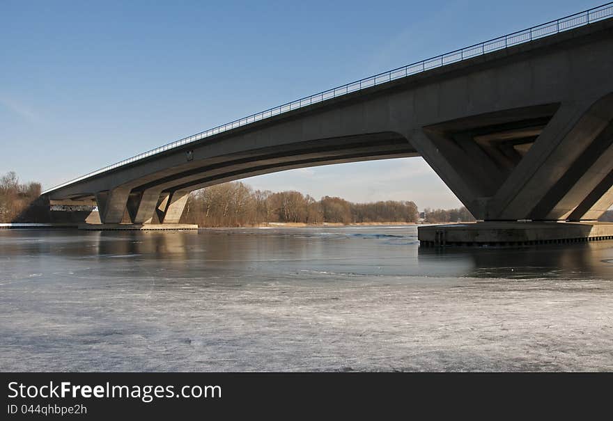 Bridge crossing the river with ice