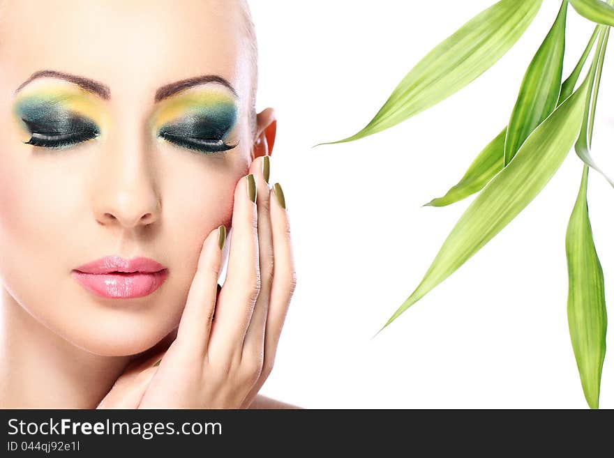 Beautiful blonde with artistic make- up and bamboo leaves. Beautiful blonde with artistic make- up and bamboo leaves