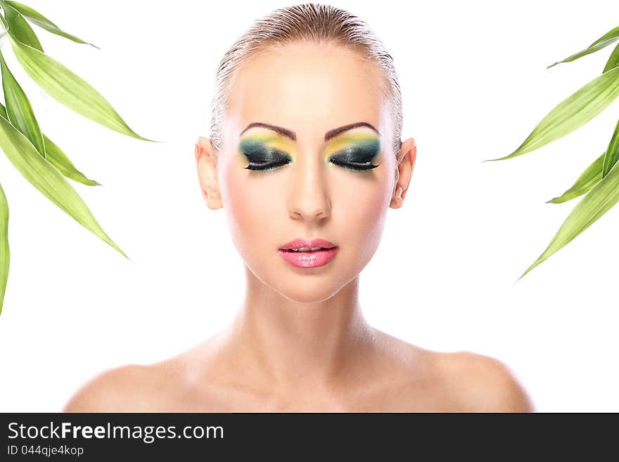 Beautiful blonde with artistic make- up and  bamboo leaves. Beautiful blonde with artistic make- up and  bamboo leaves