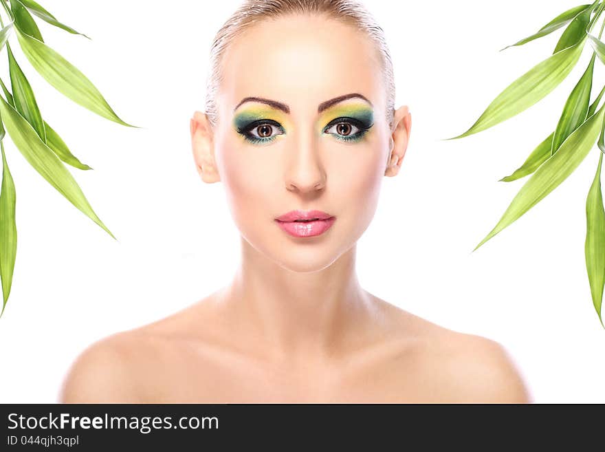 Beautiful blonde with artistic make- up and  bamboo leaves. Beautiful blonde with artistic make- up and  bamboo leaves