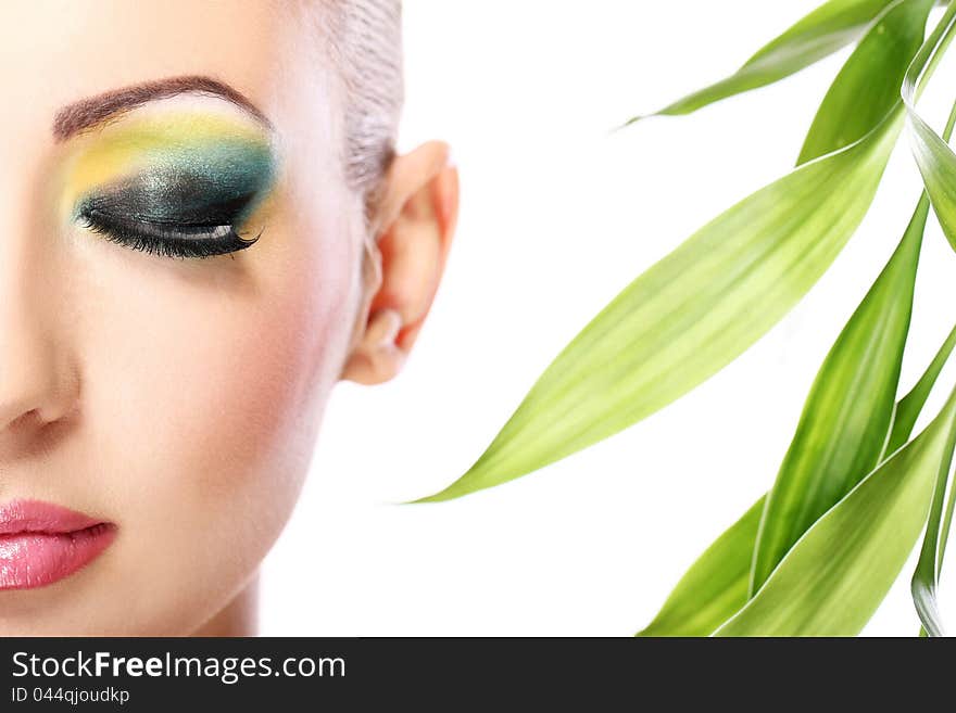 Beautiful blonde with artistic make- up and bamboo leaves. Beautiful blonde with artistic make- up and bamboo leaves