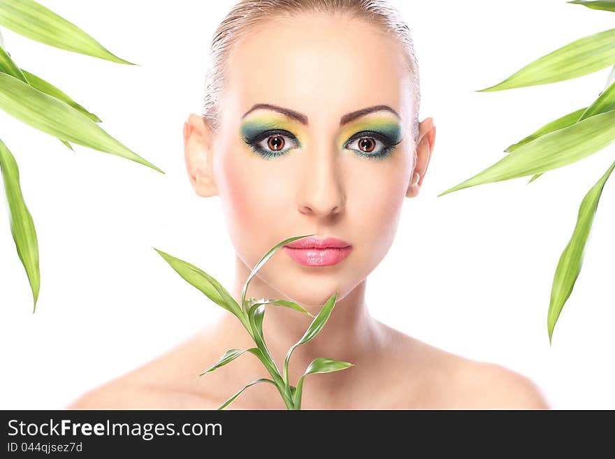 Beautiful blonde with artistic make- up and bamboo leaves. Beautiful blonde with artistic make- up and bamboo leaves