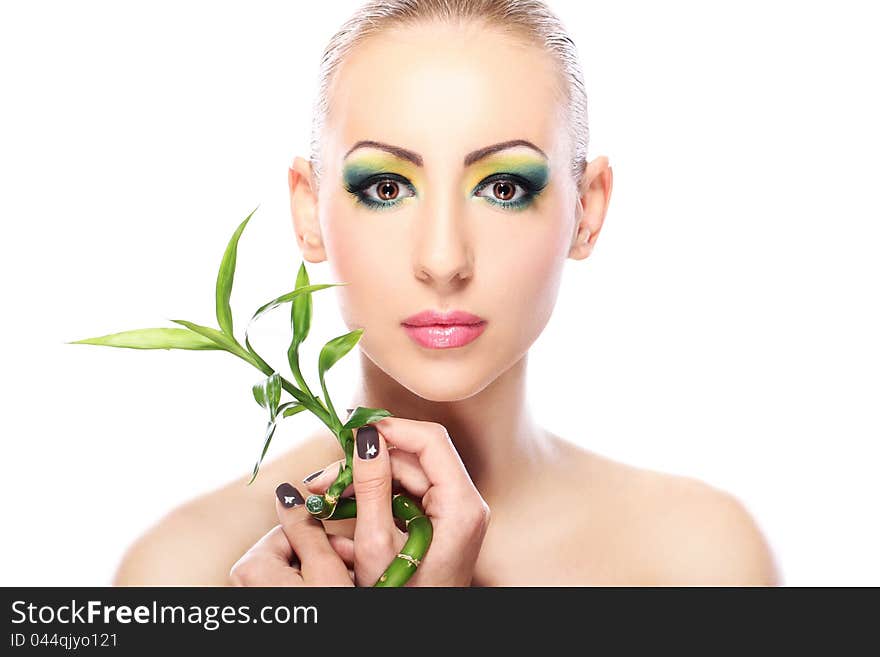 Beautiful blonde with artistic make- up and bamboo leaves. Beautiful blonde with artistic make- up and bamboo leaves