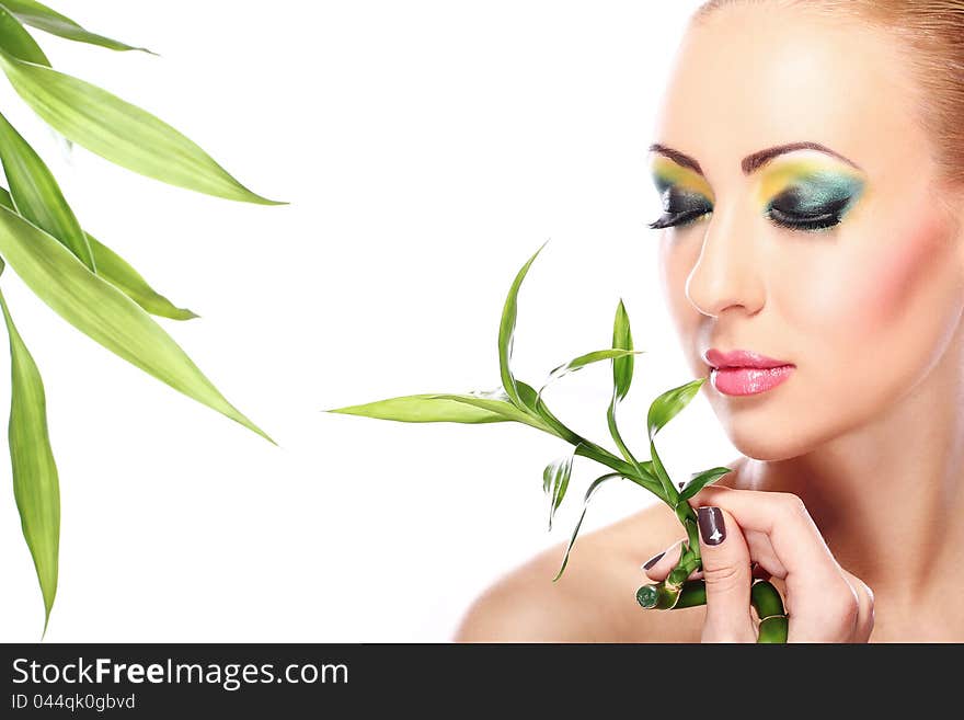 Beautiful blonde with artistic make- up and  bamboo leaves. Beautiful blonde with artistic make- up and  bamboo leaves