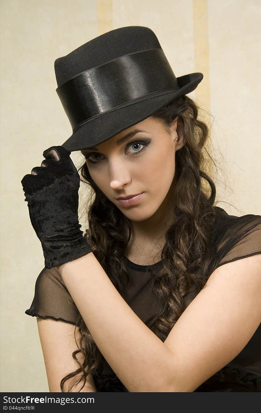 Beautiful young woman in dark hat. Beautiful young woman in dark hat