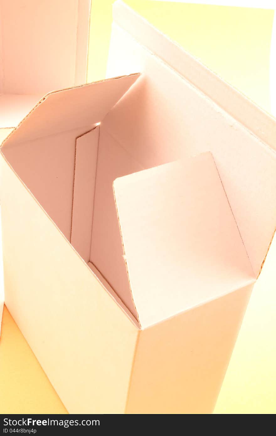 Cardboard boxes on a yellow background. Cardboard boxes on a yellow background.