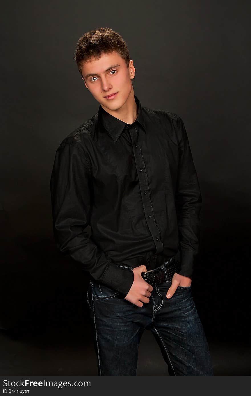 Portrait of young man on dark background. Portrait of young man on dark background.