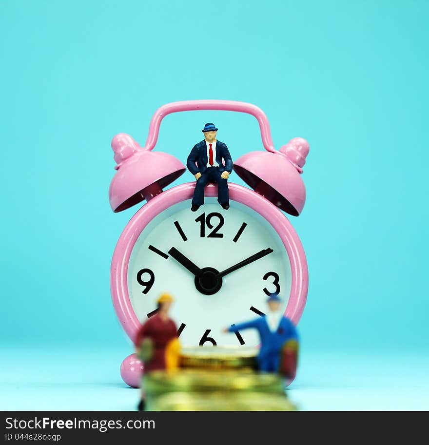 A couple walking up a golden coin stairway, with the bank manager ahead of them sat on a pastel pink alarm clock, asking the question, can you last the financial journey. A couple walking up a golden coin stairway, with the bank manager ahead of them sat on a pastel pink alarm clock, asking the question, can you last the financial journey.