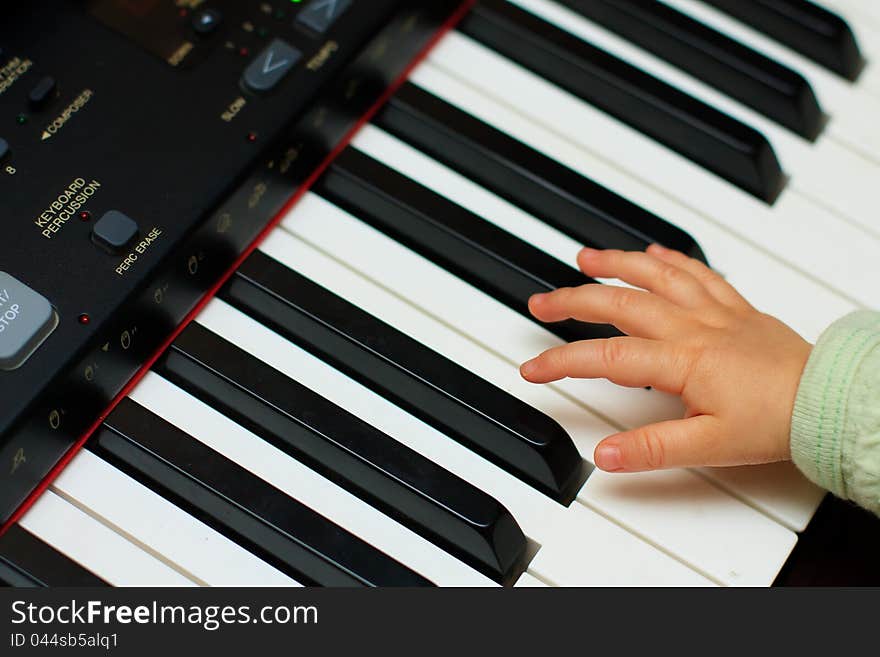 Baby hand about to play a piano. Baby hand about to play a piano