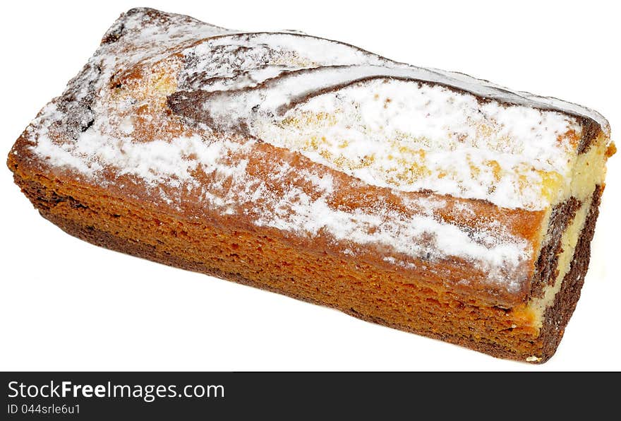 A vanilla and chocolate sponge cake topped with powdered sugar isolated on a white background