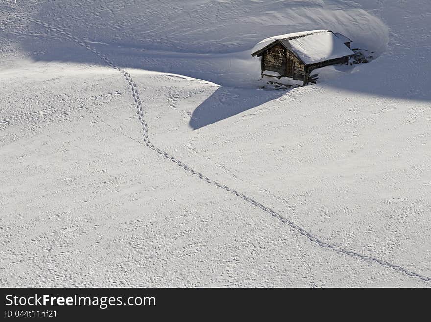 Snowbound hut with snow shoe tracks