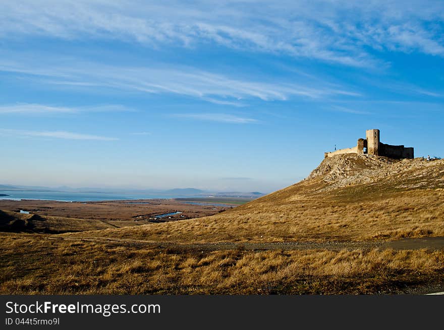 Ruins of medieval fortress Enisala, Romania, Europe. Background with sky and clouds.