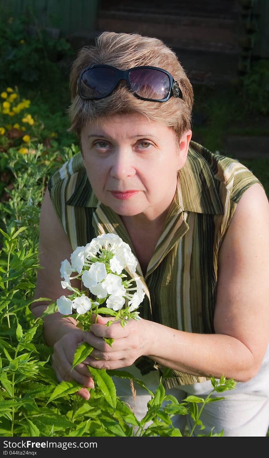 Portrait of a woman with a blooming phlox