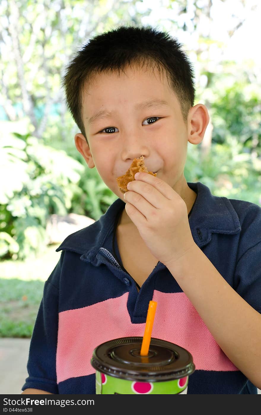 Happy Asian boy smile and eating muffin. Happy Asian boy smile and eating muffin