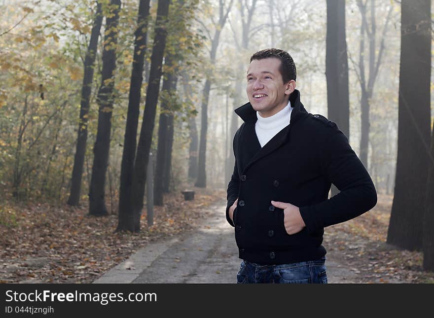 Young men posing in autumn park