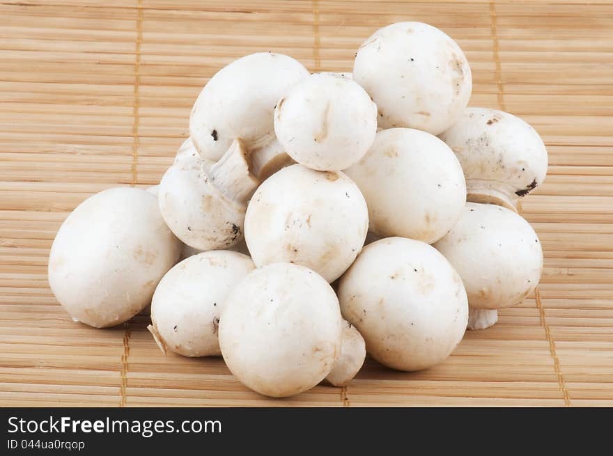 White Champignon Mushroom isolated on wooden background