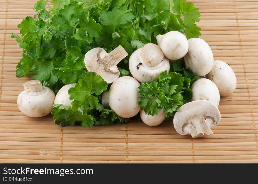 White Champignon Mushroom with parsley on wooden background. White Champignon Mushroom with parsley on wooden background