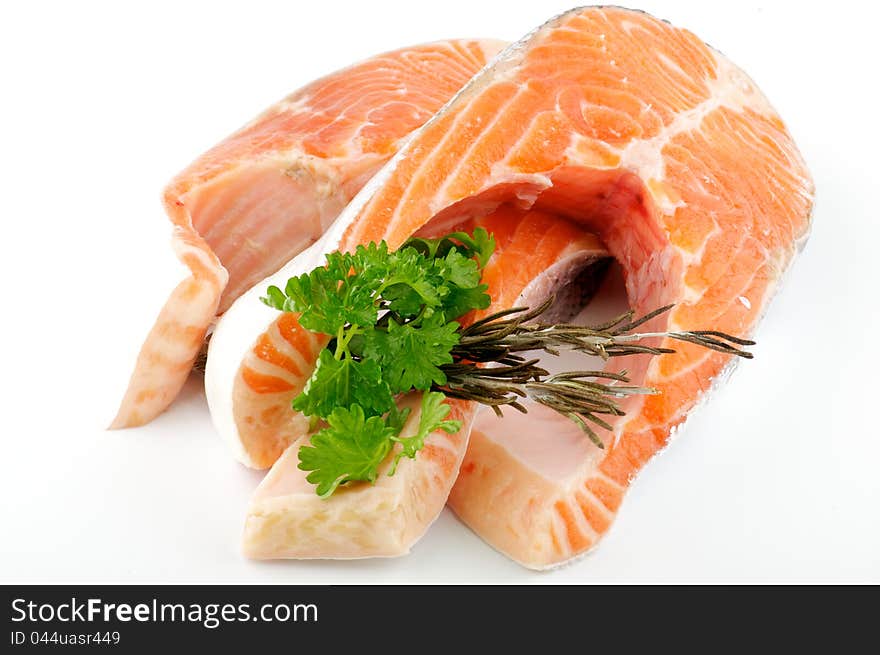 Fresh steak of trout with parsley and rosemary isolared on white background