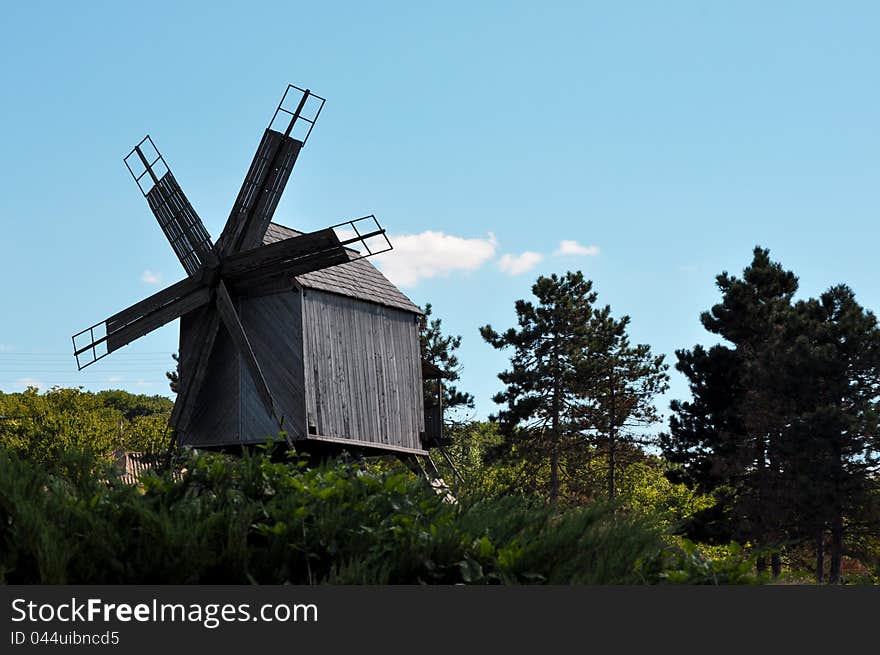 Old wooden mill near a monastery