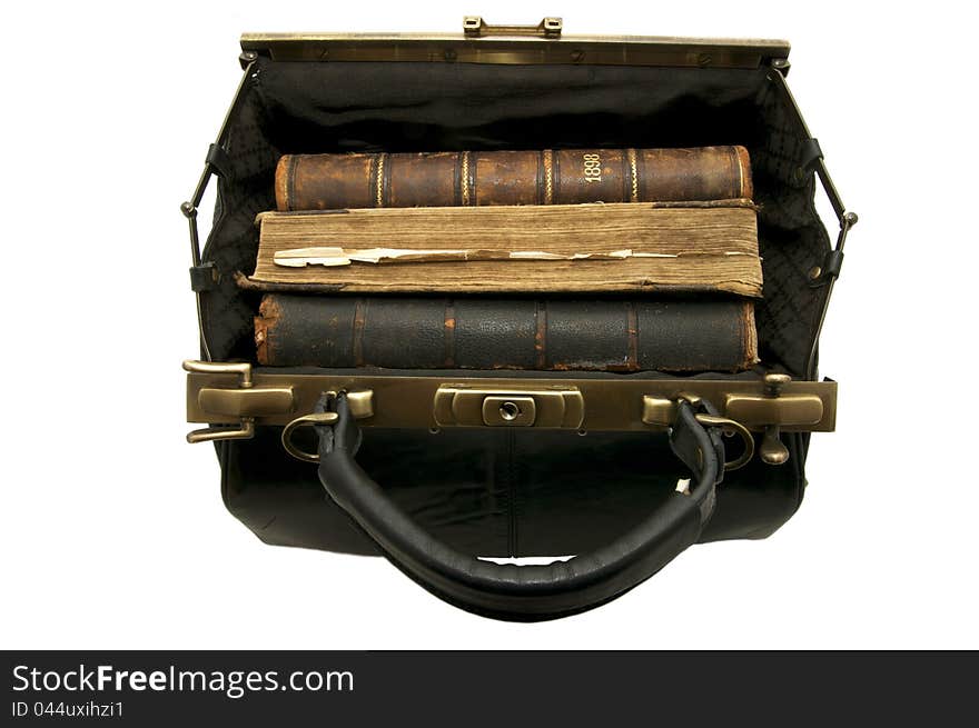 Old books in the doctor's hand-bag on a white background. Old books in the doctor's hand-bag on a white background