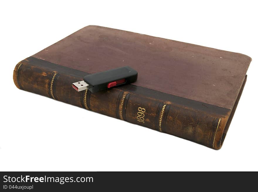 Old books and flash drive on a white background