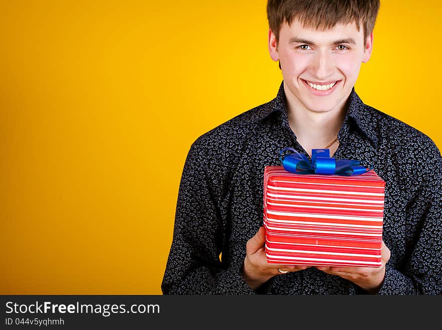 Present gift holding man looking camera