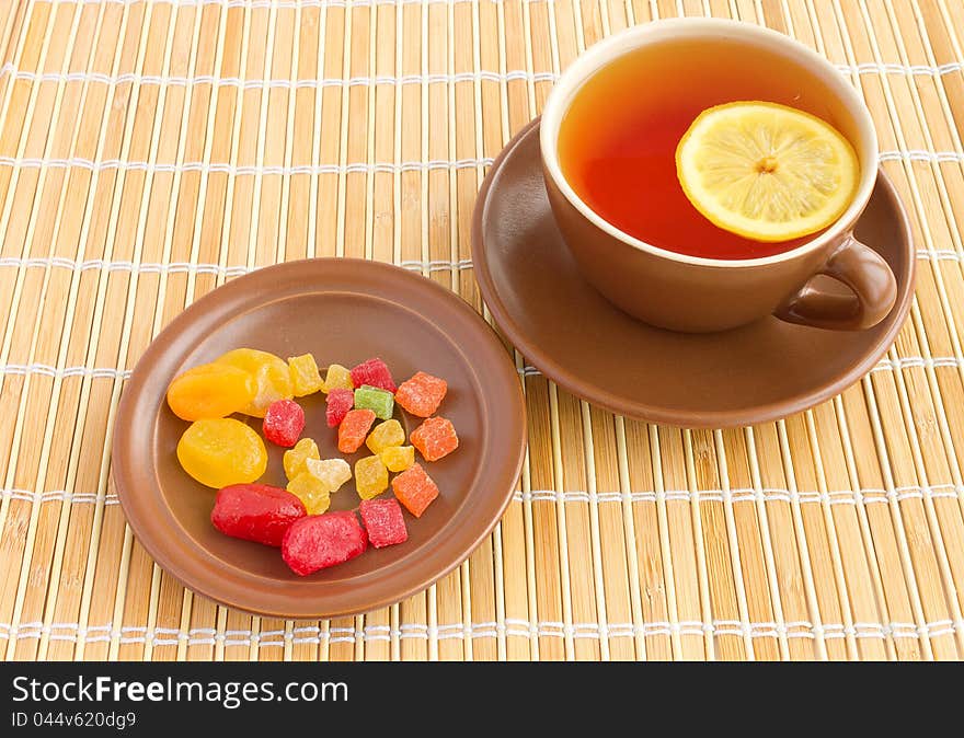 Cup of tea with candied fruits